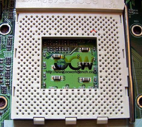 The CPU socket and red lines showing where two jumpers should be inserted to get 1.675V Vcore.